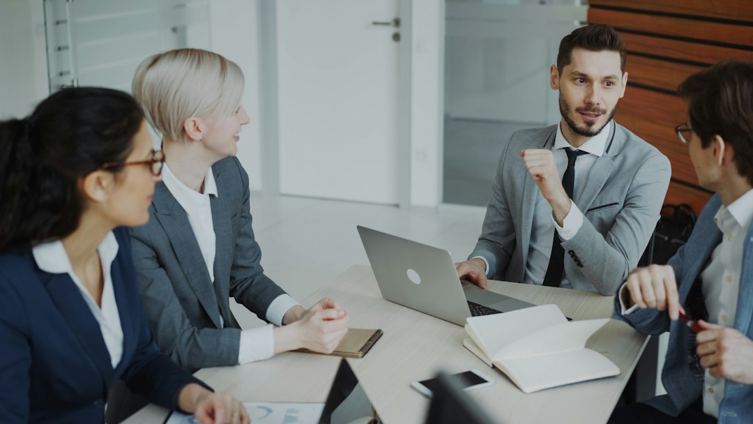 Business professionals reviewing plans. Photo by Vitaly Gariev on Unsplash.